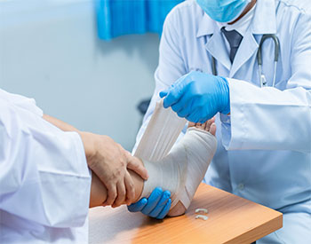 Wound Care ClinicClose-up hand wear medical gloves Of Doctor Hand Tying Bandage On The Leg Of Patient In Clinic, osteophytes and heel, fascia